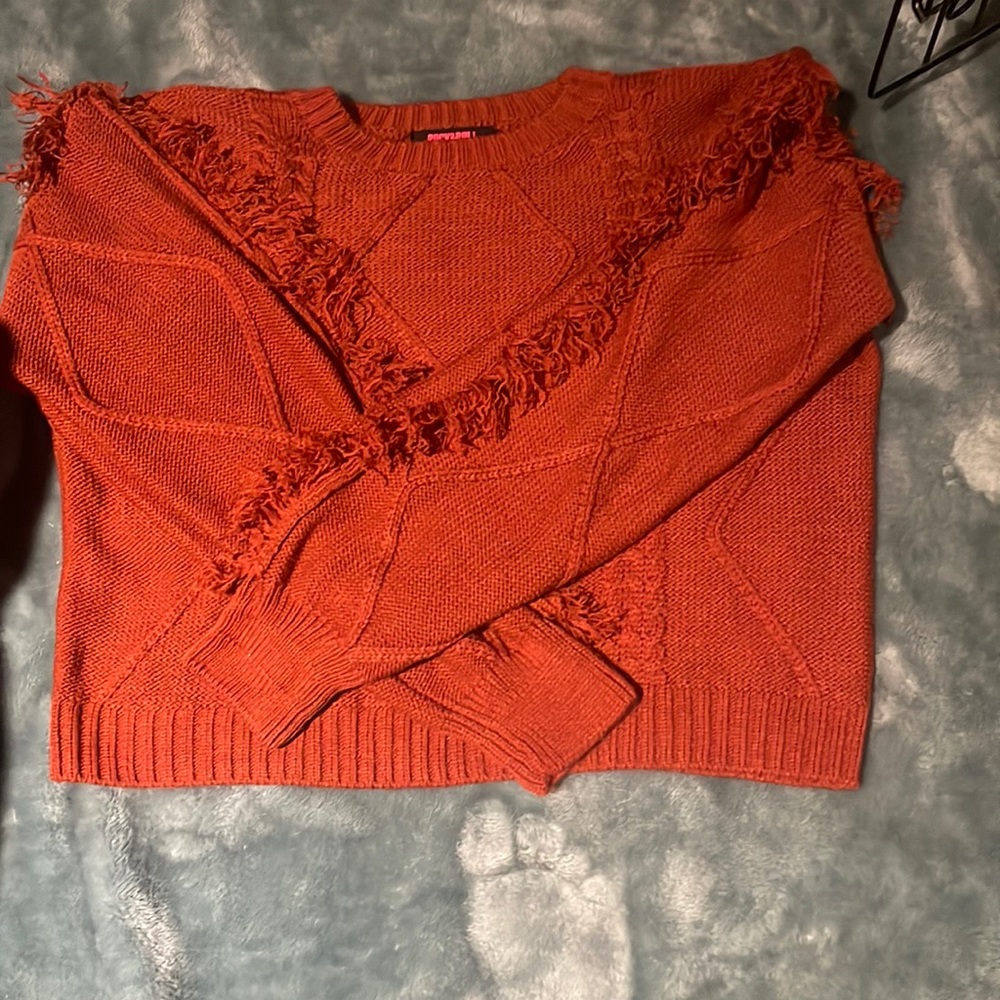 Red sweeter with fringe. Worn twice. Rock and roll denim. In excellent shape
